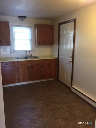 a kitchen with granite countertop cabinets stainless steel appliances and a window