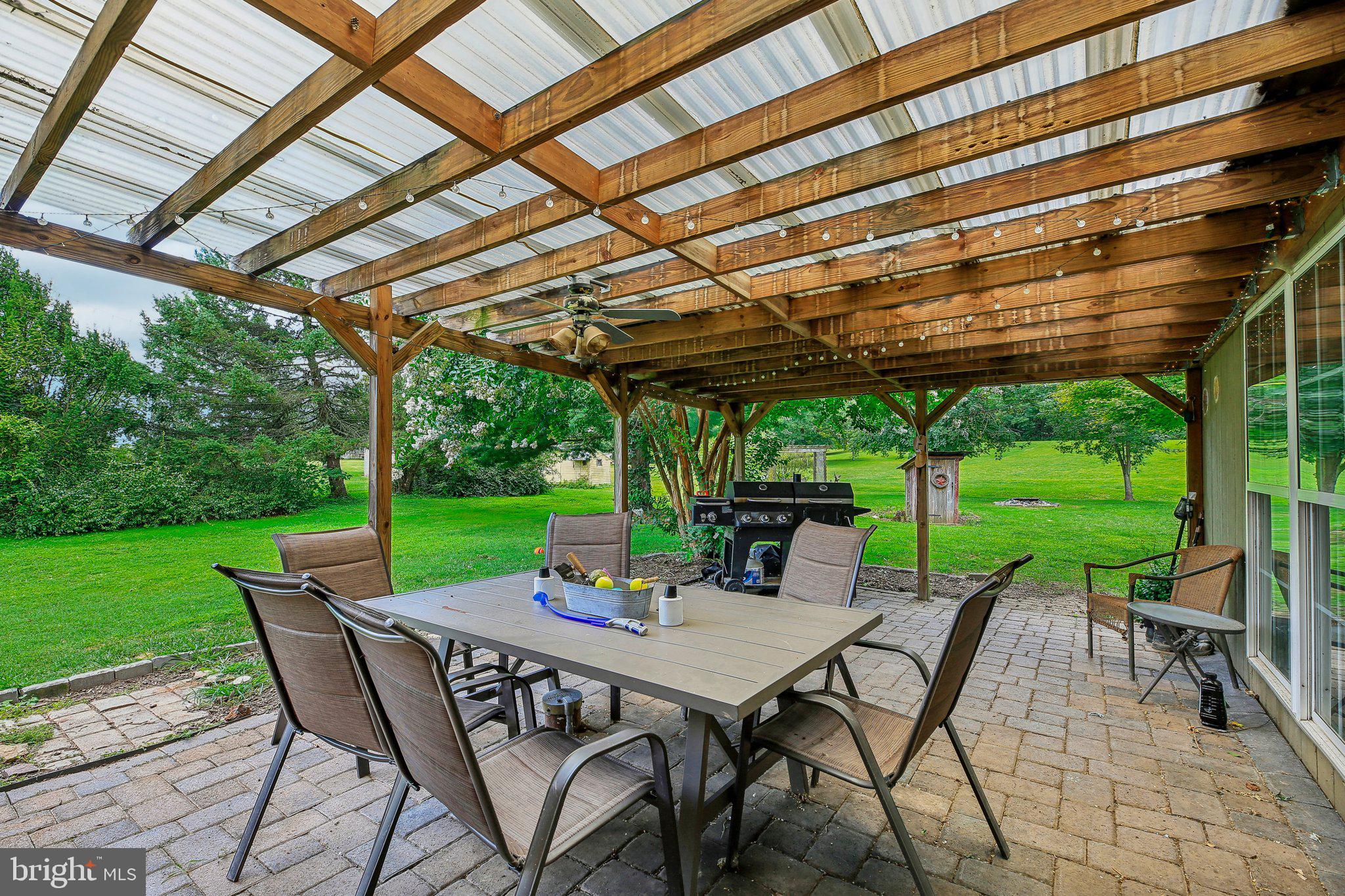 857 White Hall Road Littlestown, PA 17340 - Photo 17 of 32 a view of a patio with a table chairs and a backyard