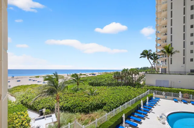 a view of a swimming pool with a yard