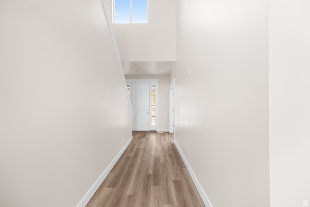1510 West 600 North, Unit GE 04 Mapleton, UT 84664 - Photo 6 of 21 Entryway featuring wood-finish flooring, a white paneled front door with sidelight, and a high transom window