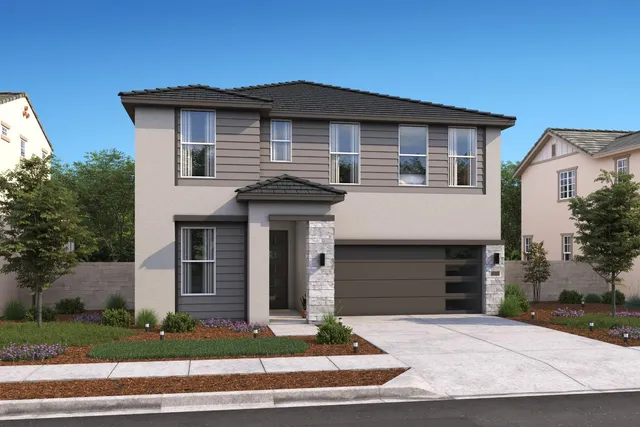 a front view of a house with a yard and garage