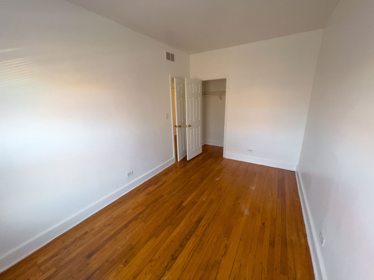 115 East 60th Street, Unit 2 Chicago, IL 60637 - Photo 8 of 11 a view of wooden floor in a room