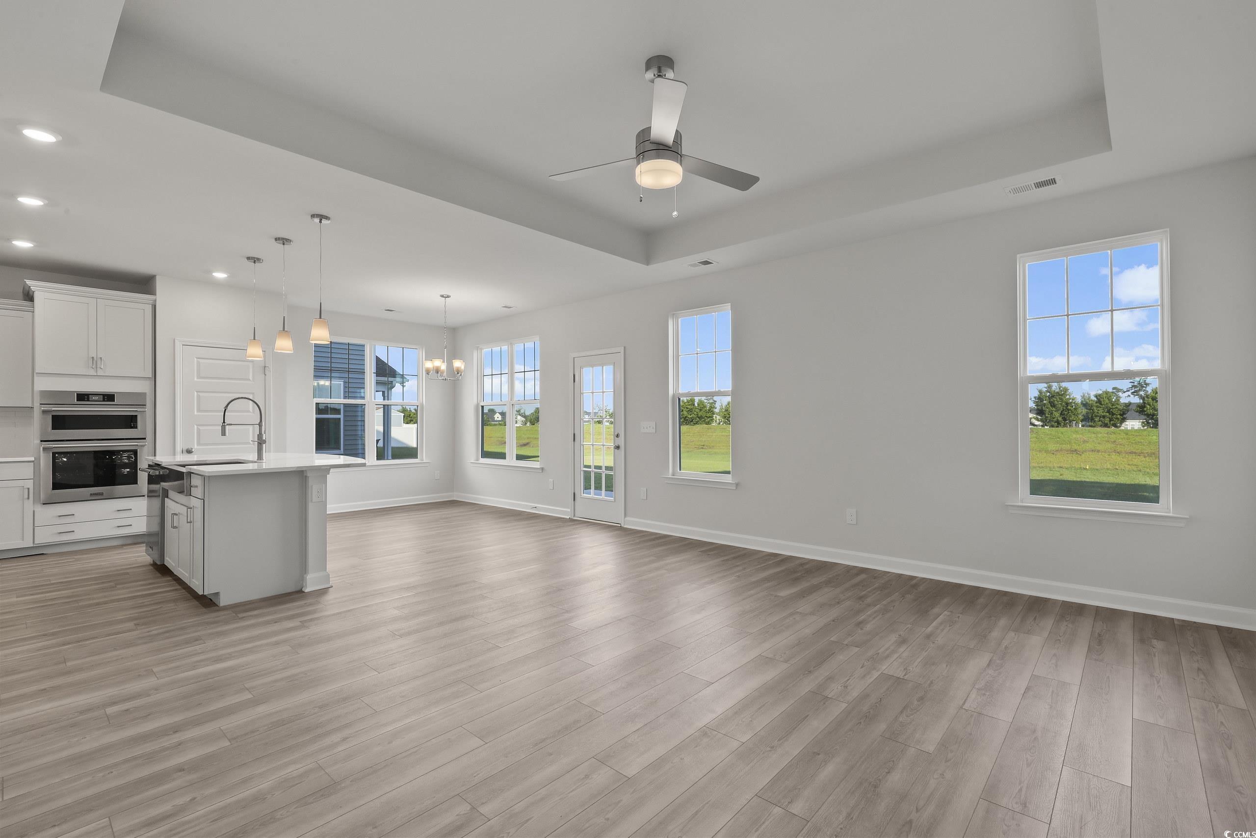 771 Enchantment Loop Myrtle Beach, SC 29588 - Photo 12 of 40 Kitchen with an island with sink, a raised ceiling