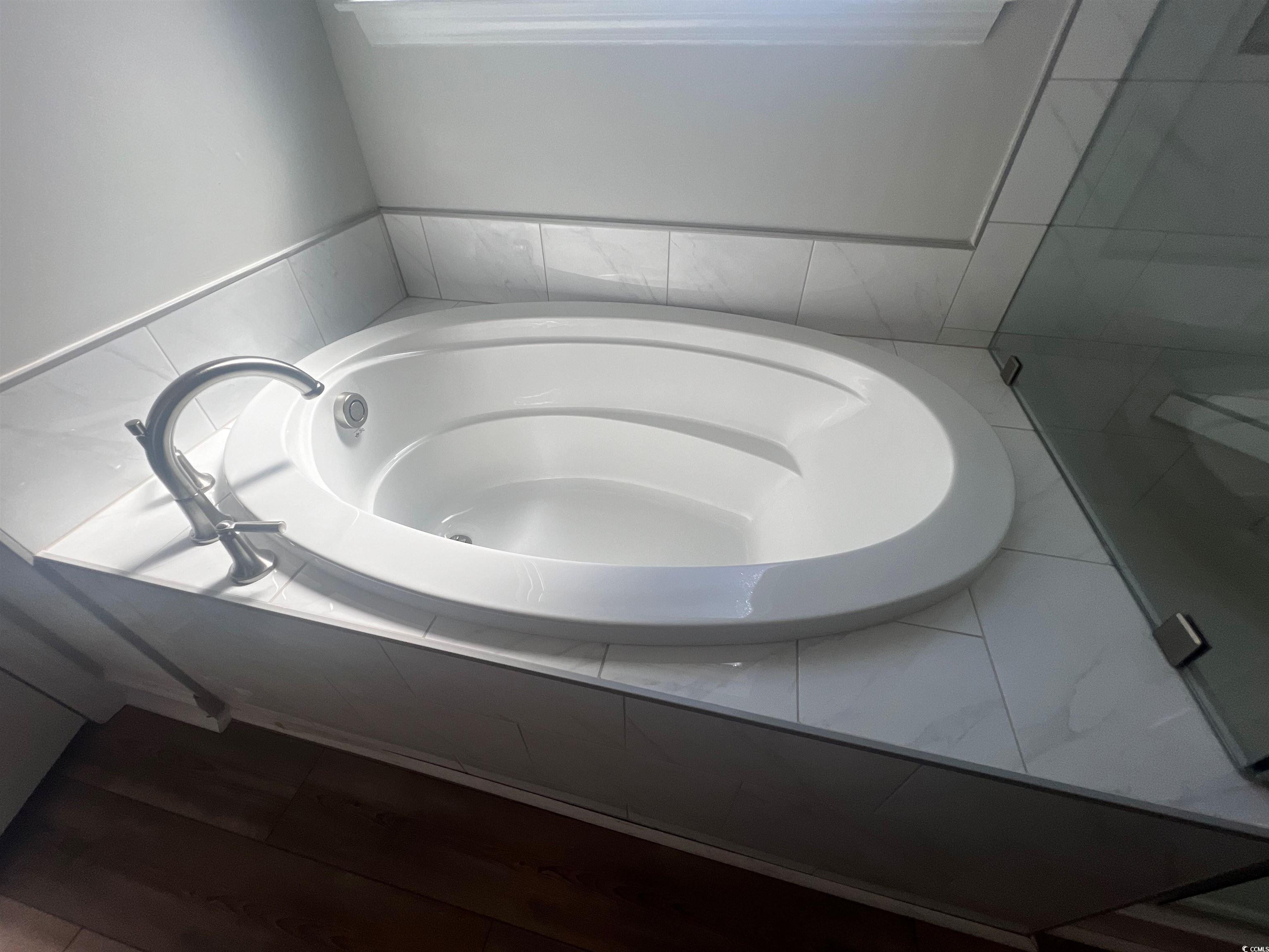 771 Enchantment Loop Myrtle Beach, SC 29588 - Photo 15 of 40 Bathroom with hardwood / wood-style flooring and t