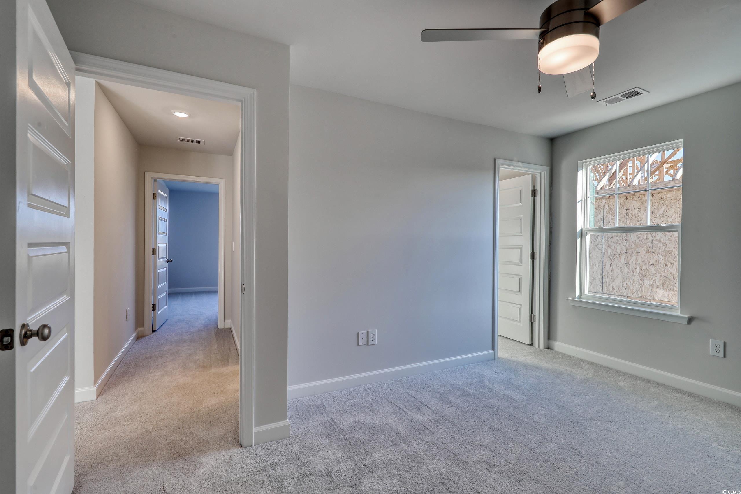 771 Enchantment Loop Myrtle Beach, SC 29588 - Photo 19 of 40 Spare room with ceiling fan and light carpet