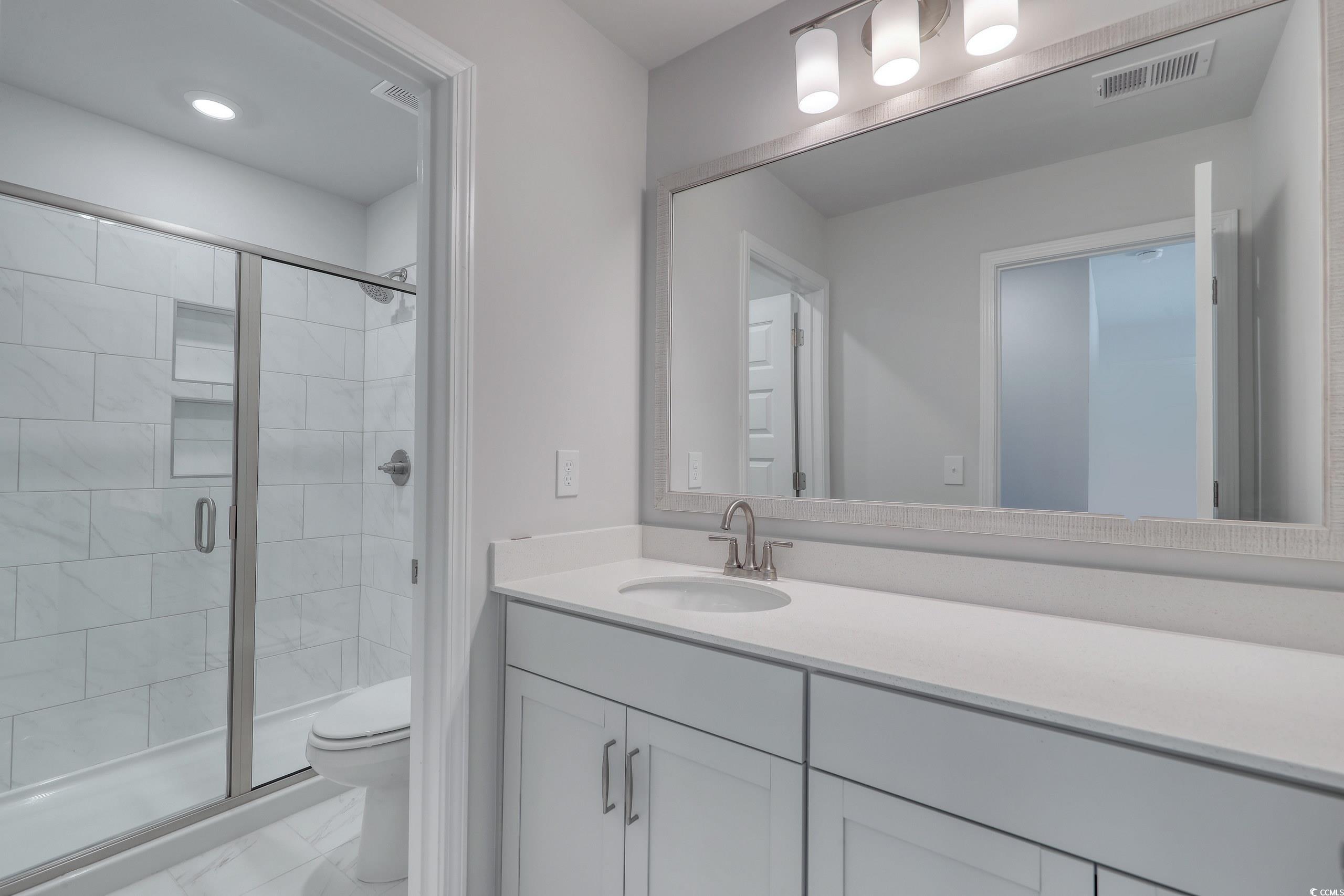 771 Enchantment Loop Myrtle Beach, SC 29588 - Photo 20 of 40 Bathroom with vanity, toilet, and walk in shower