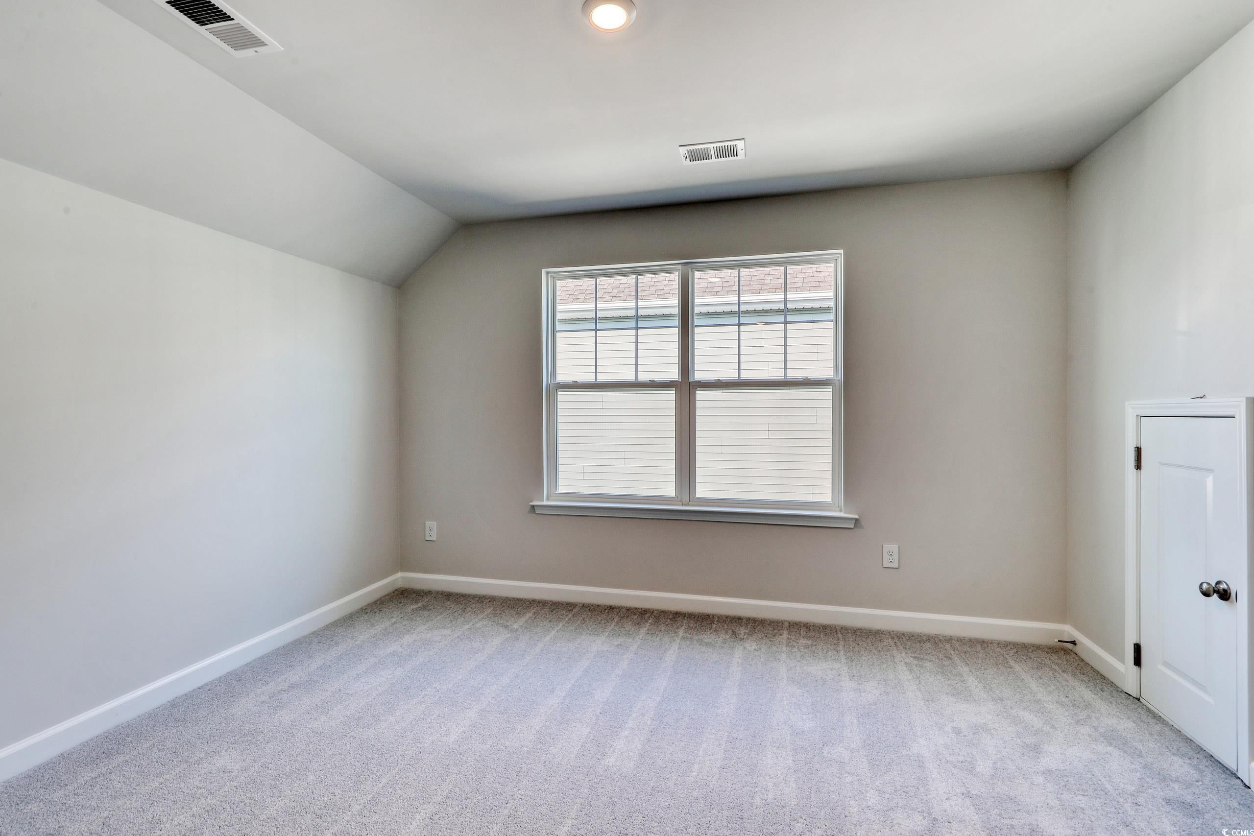 771 Enchantment Loop Myrtle Beach, SC 29588 - Photo 21 of 40 Unfurnished room featuring lofted ceiling and ligh