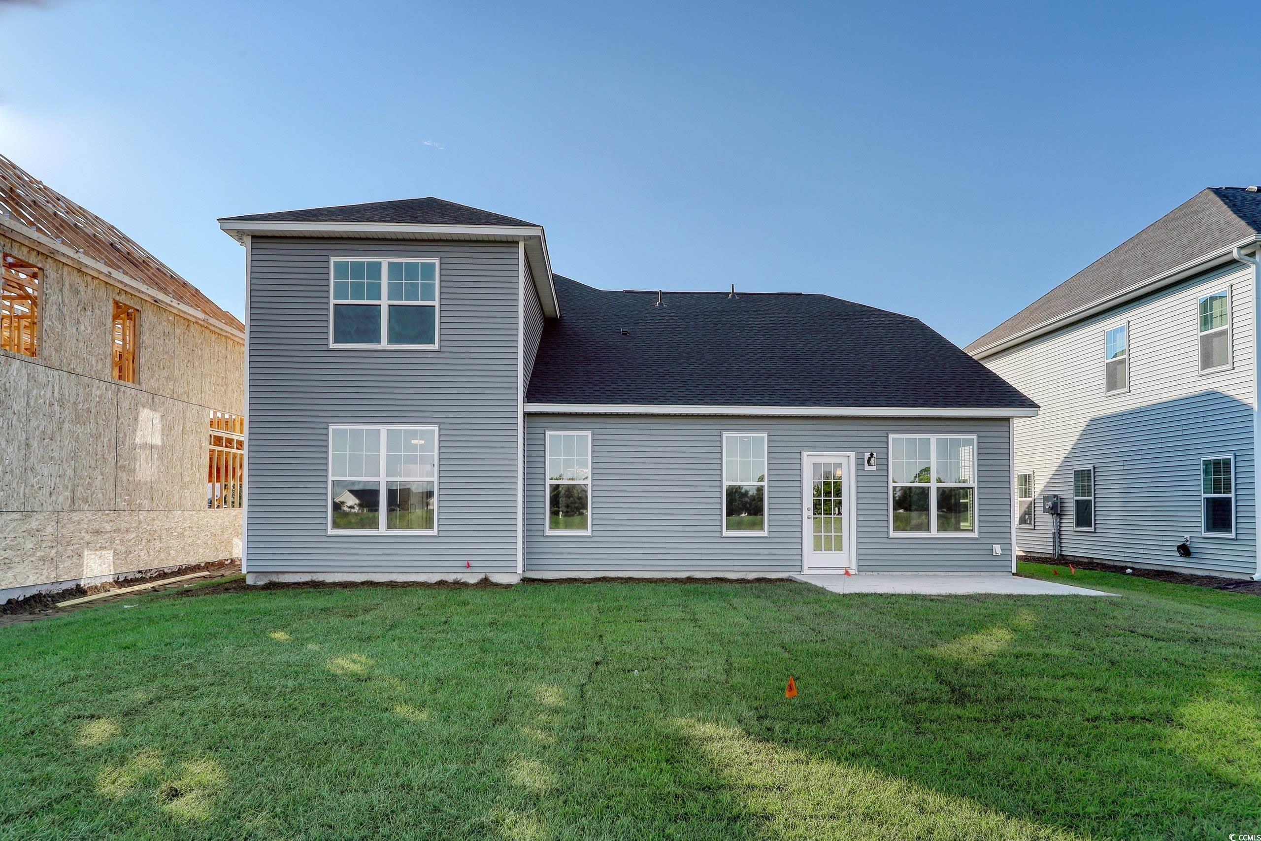 771 Enchantment Loop Myrtle Beach, SC 29588 - Photo 23 of 40 Rear view of house with a patio area and a yard