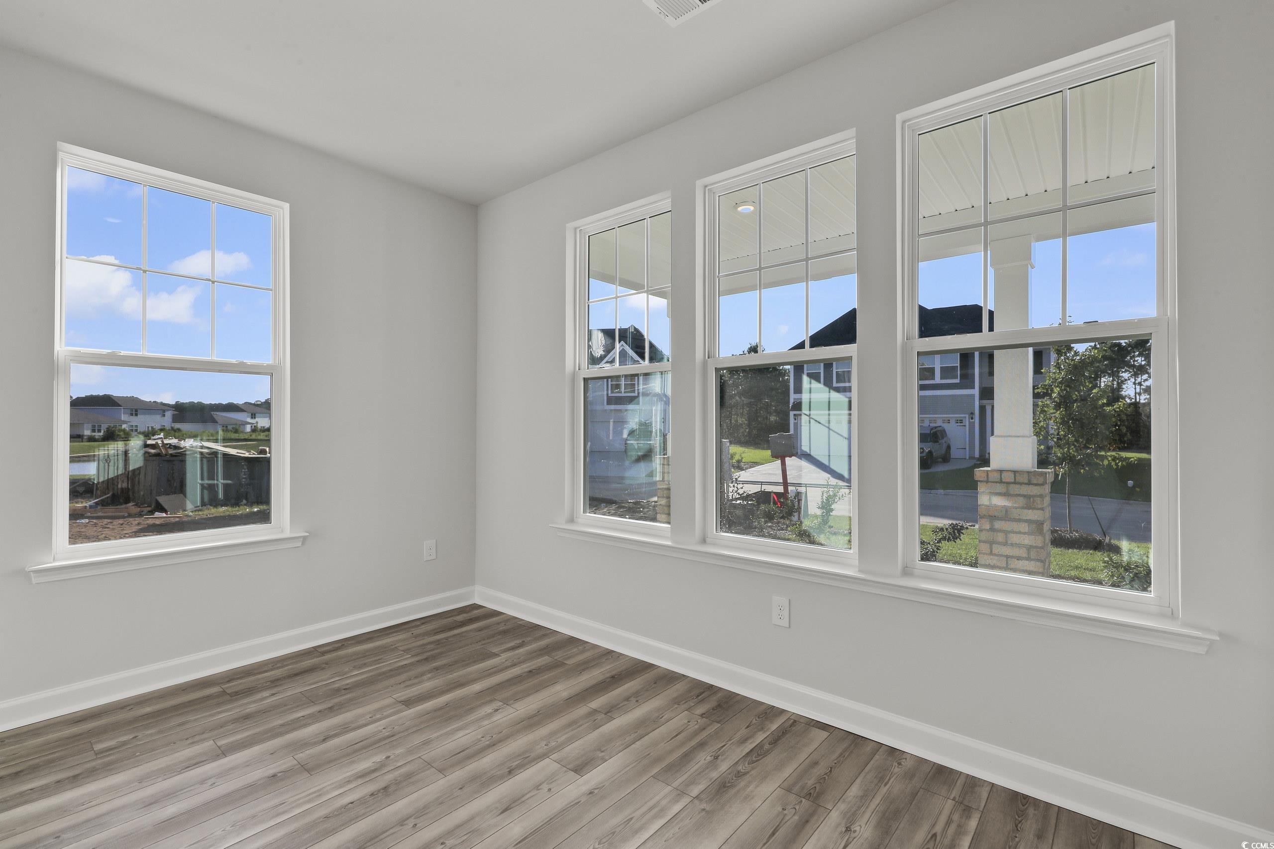 771 Enchantment Loop Myrtle Beach, SC 29588 - Photo 4 of 40 Unfurnished room with hardwood / wood-style floori