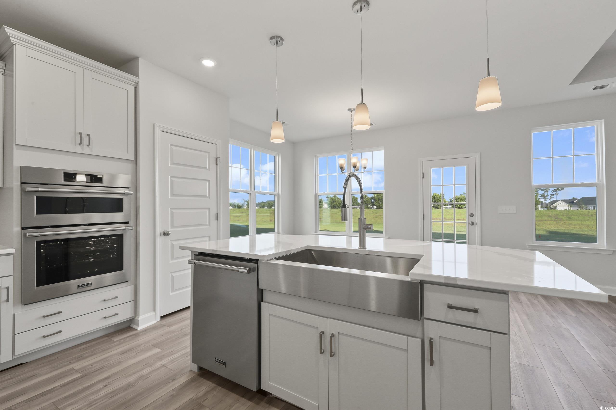 771 Enchantment Loop Myrtle Beach, SC 29588 - Photo 8 of 40 Kitchen featuring light wood-type flooring, stainl