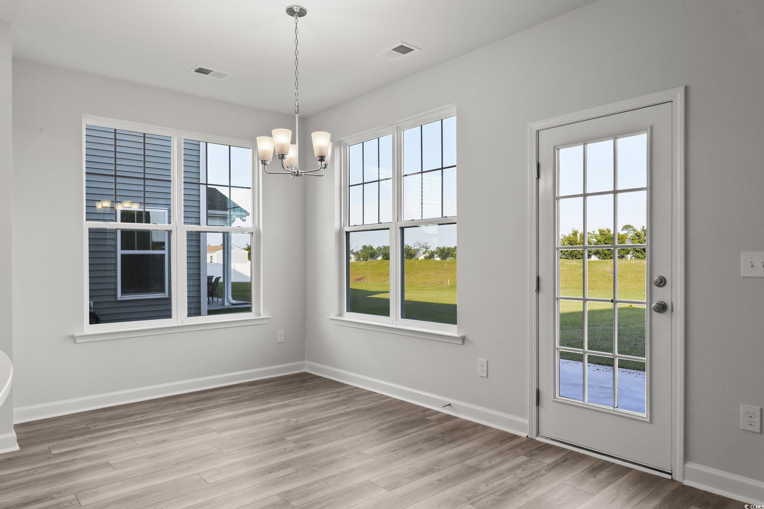 771 Enchantment Loop Myrtle Beach, SC 29588 - Photo 9 of 40 Unfurnished dining area with light hardwood / wood