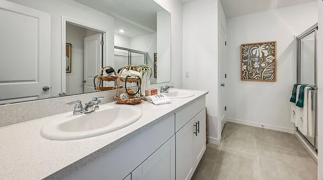 a bathroom with 2 sink and a mirror