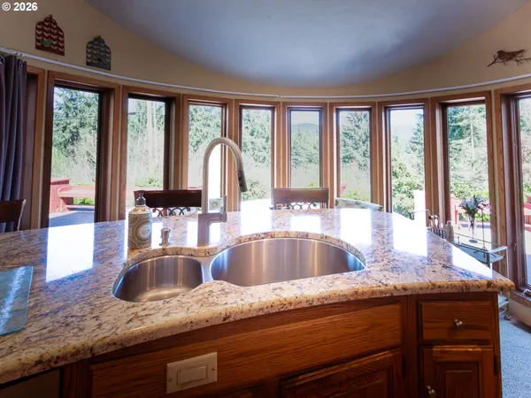 a kitchen with granite countertop a sink and a large window