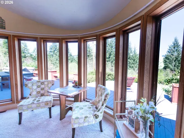 a living room with furniture and floor to ceiling windows