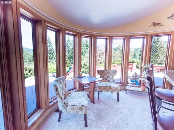 a living room with furniture and floor to ceiling windows