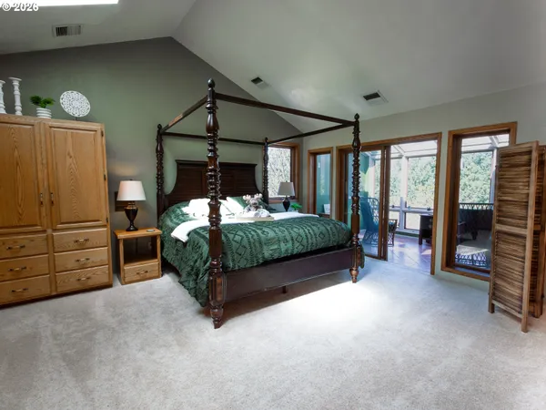 a bedroom with a bed and a large window