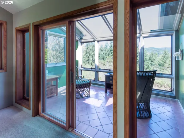 a view of a room with a dining table and chairs