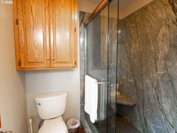 a bathroom with a toilet and shower