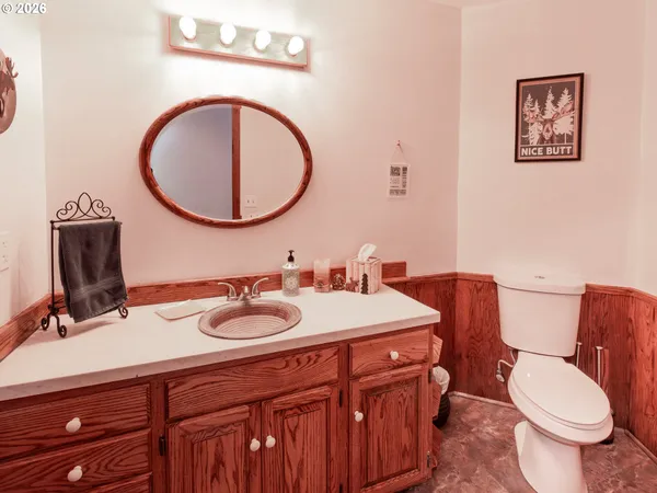 a bathroom with a toilet a sink and a mirror