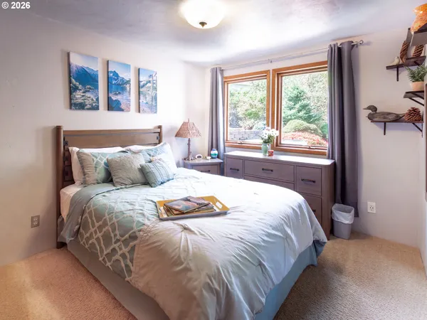 a spacious bedroom with a bed and a large window