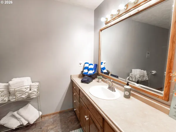 a bathroom with a sink vanity and a mirror