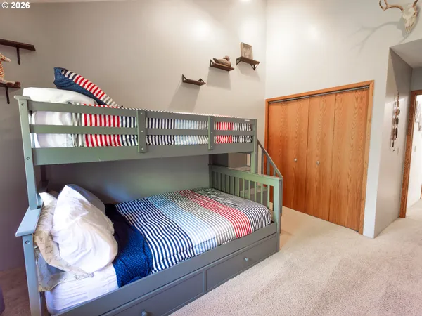 a bedroom with bed and a chandelier