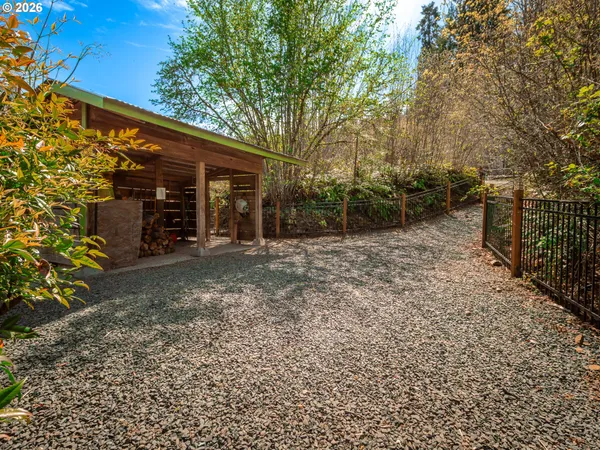 a view of a backyard with large trees