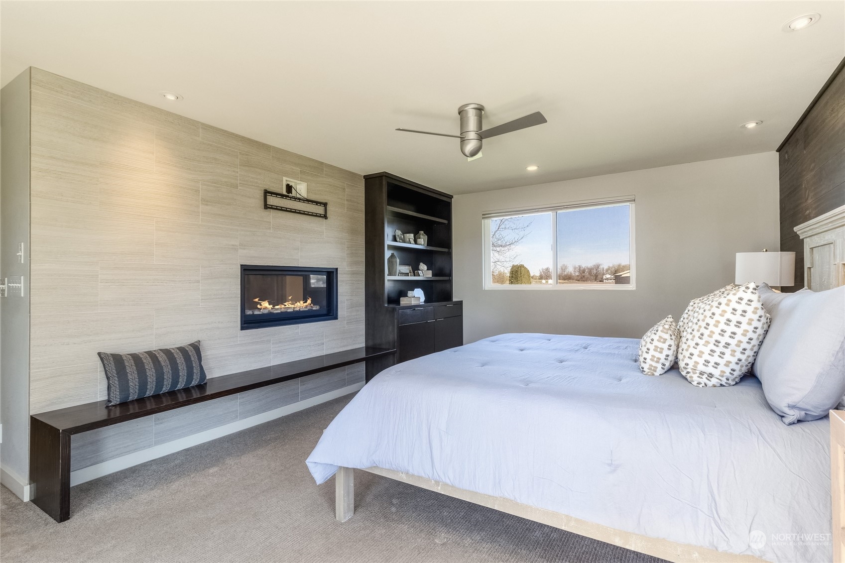 1479 Spring Branch Road Walla Walla, WA 99362 - Photo 15 of 40 a spacious bedroom with a bed a couch and a flat screen tv