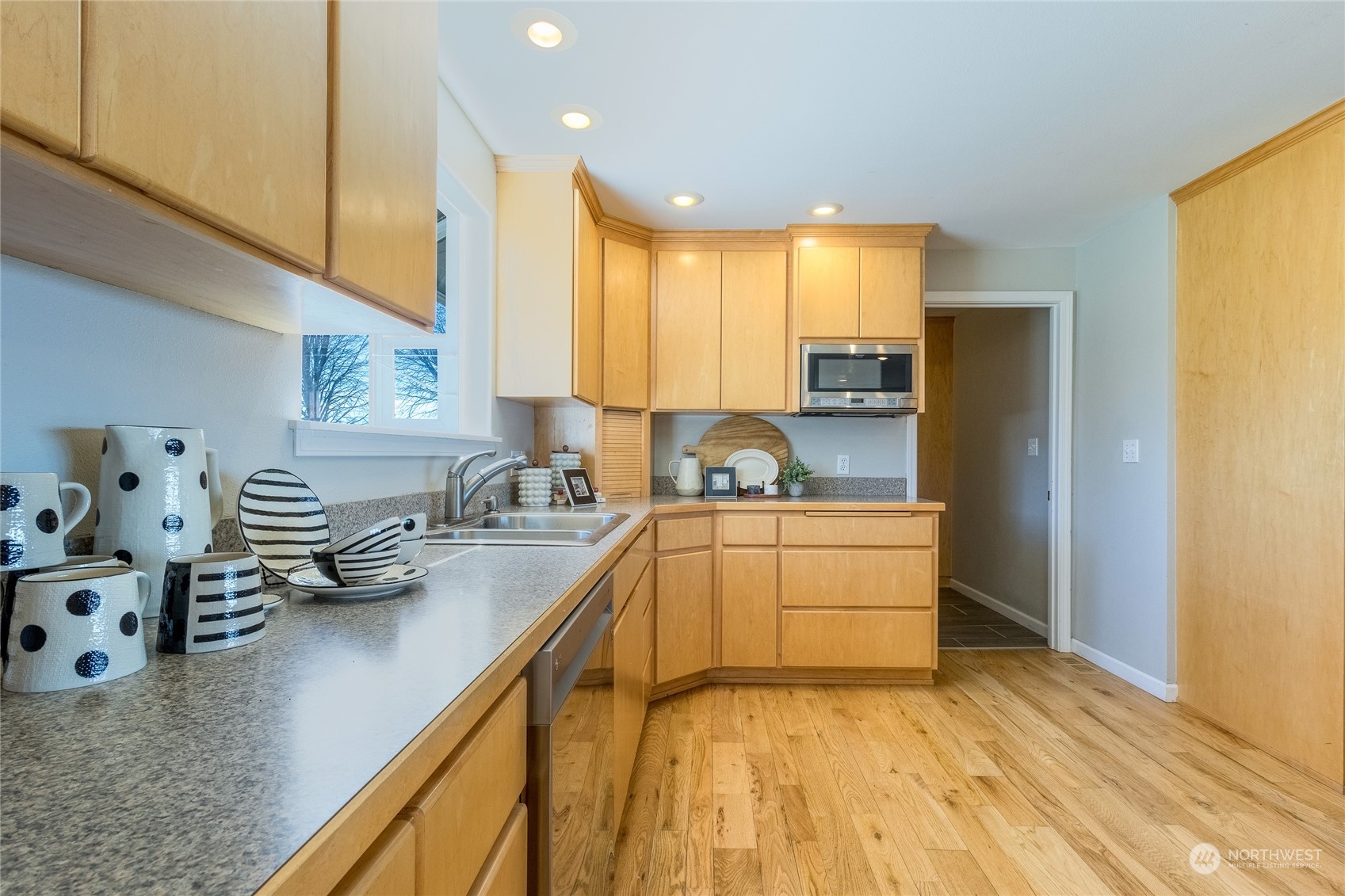 1479 Spring Branch Road Walla Walla, WA 99362 - Photo 8 of 40 a kitchen with a sink a stove cabinets and a wooden floor
