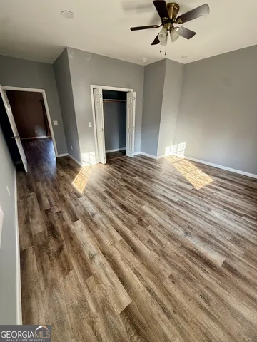a view of a livingroom with a hall and wooden floor