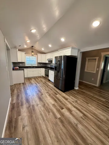 a view of an empty room and wooden floor