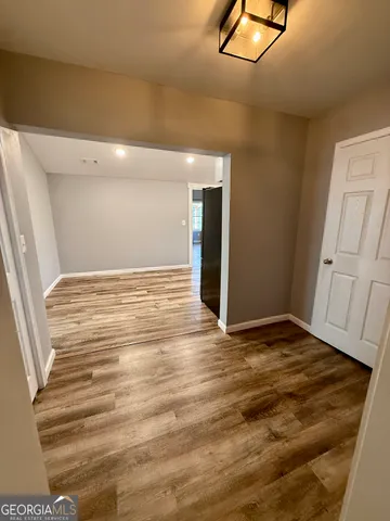 a view of a hallway view with wooden floor and staircase