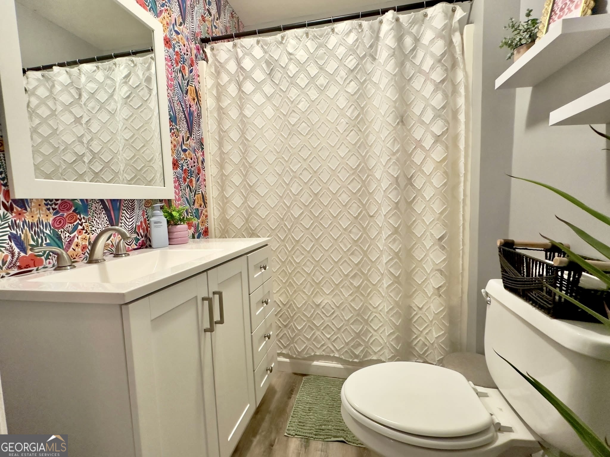 41 6th Street Trion, GA 30753 - Photo 28 of 60 a bathroom with a sink a toilet and a shower curtain