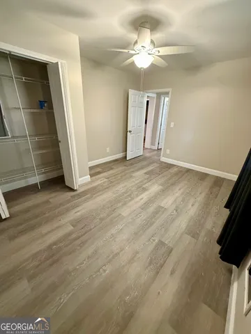 a view of a yard with wooden fence and a large tree