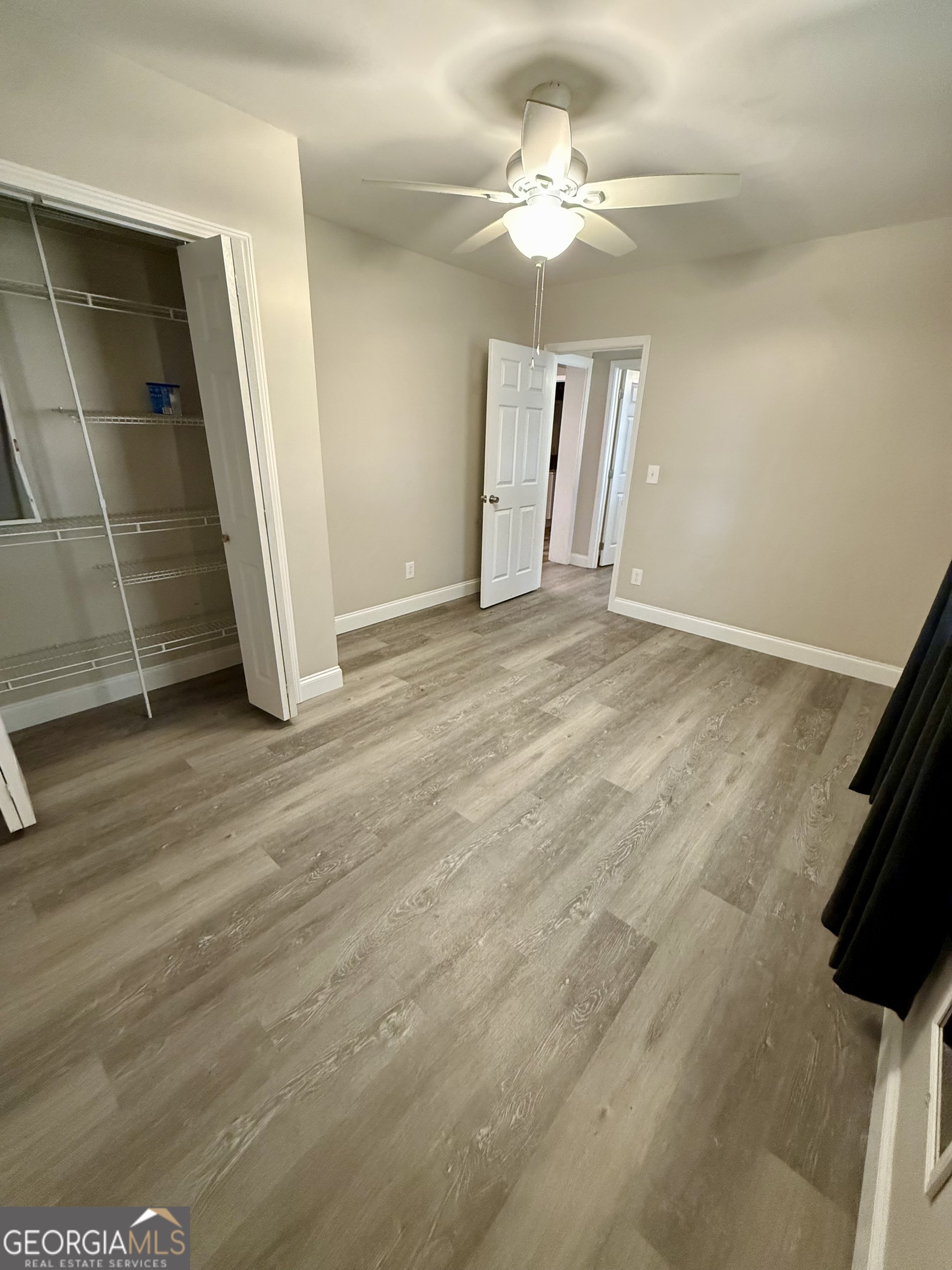 41 6th Street Trion, GA 30753 - Photo 44 of 60 an empty room with wooden floor and ceiling fan