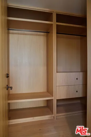 a bathroom with a toilet and a mirror