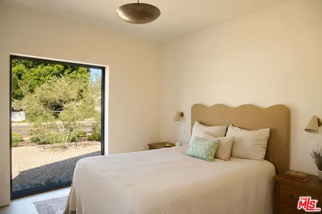 a bedroom with a bed and a lamp