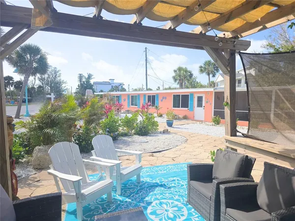 a view of a patio with couches table and chairs and potted plants