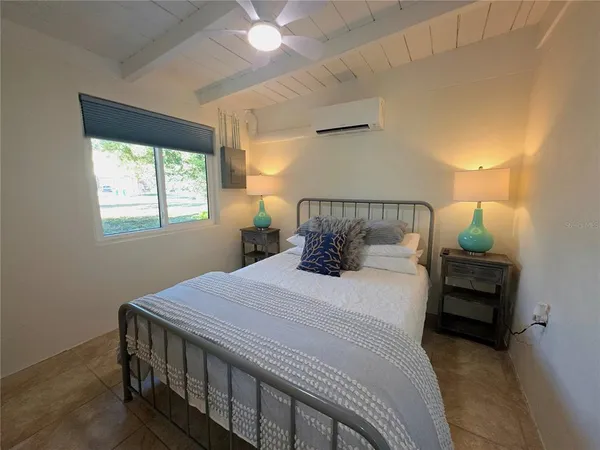 a bedroom with a bed and window