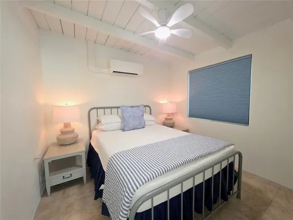 a bedroom with a bed and a night stand