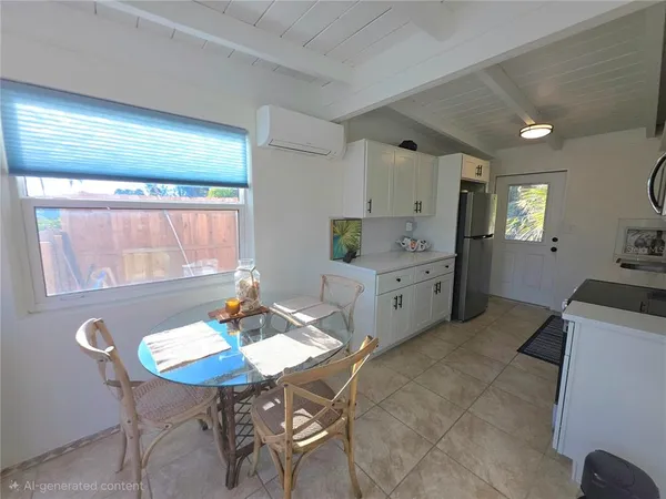 a kitchen with a table chairs and white cabinets