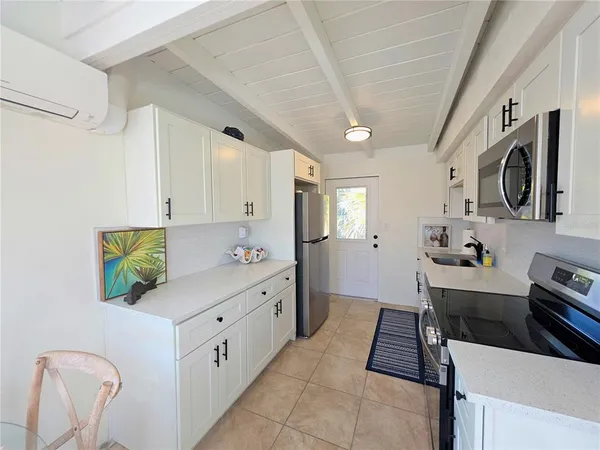 a kitchen with a sink cabinets and appliances
