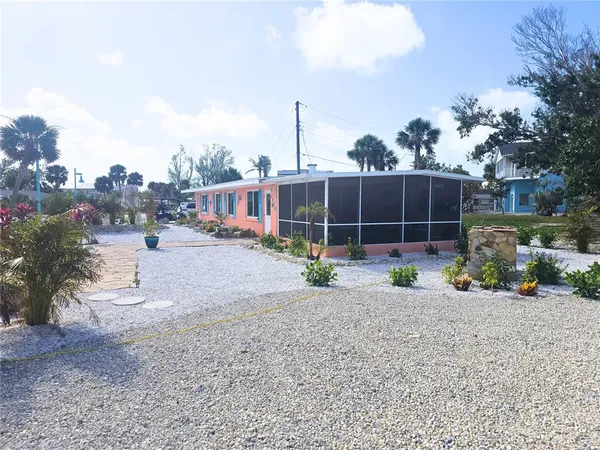 a view of a house with a yard and sitting area
