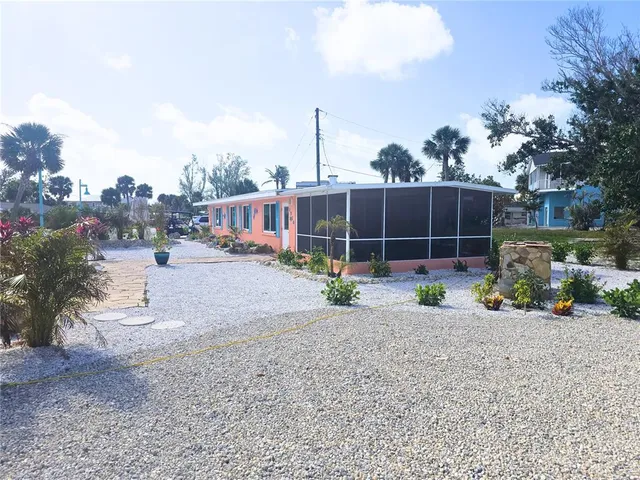 a view of a house with a yard and sitting area