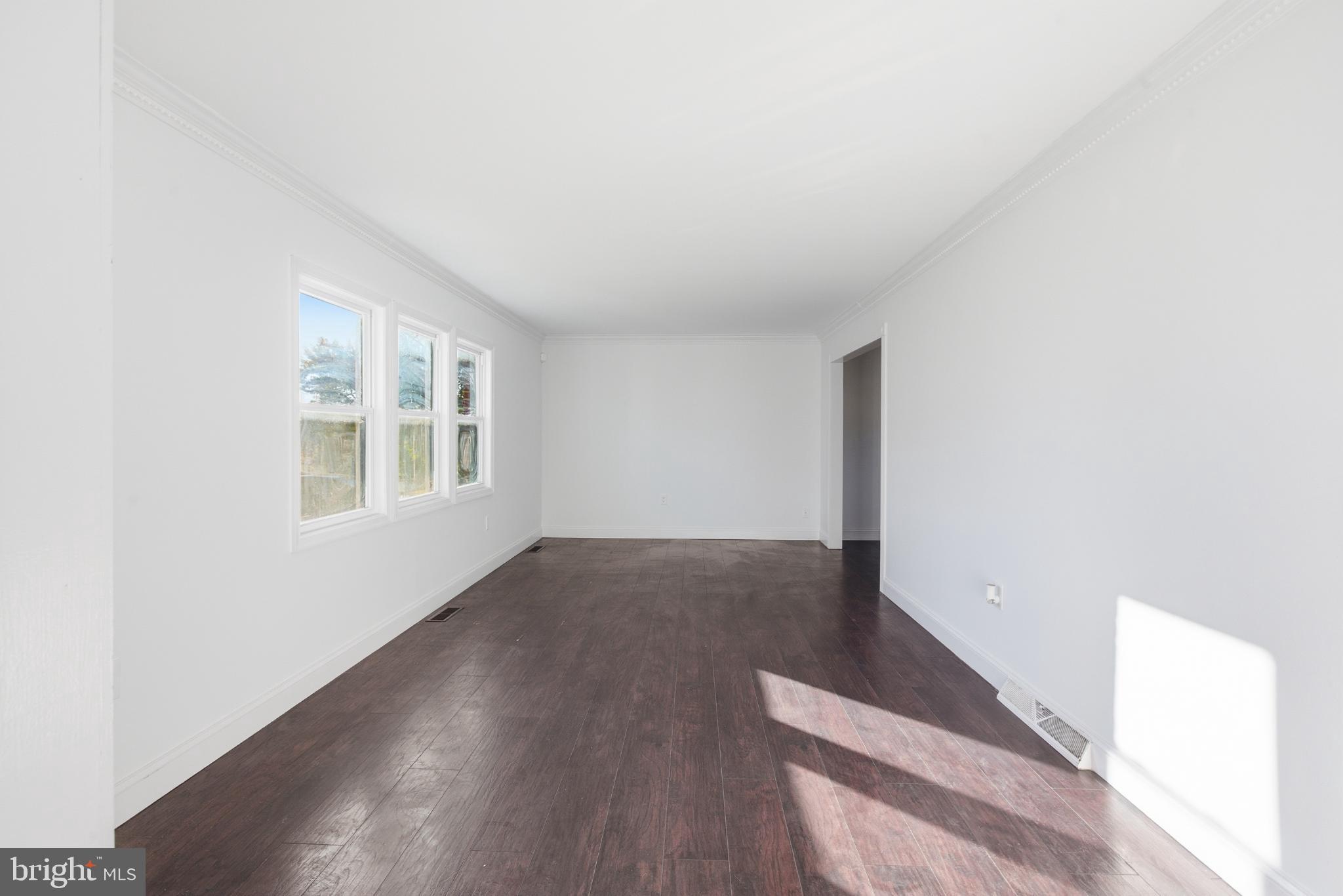 1826 Hanson Road Edgewood, MD 21040 - Photo 4 of 22 an empty room with wooden floor and windows