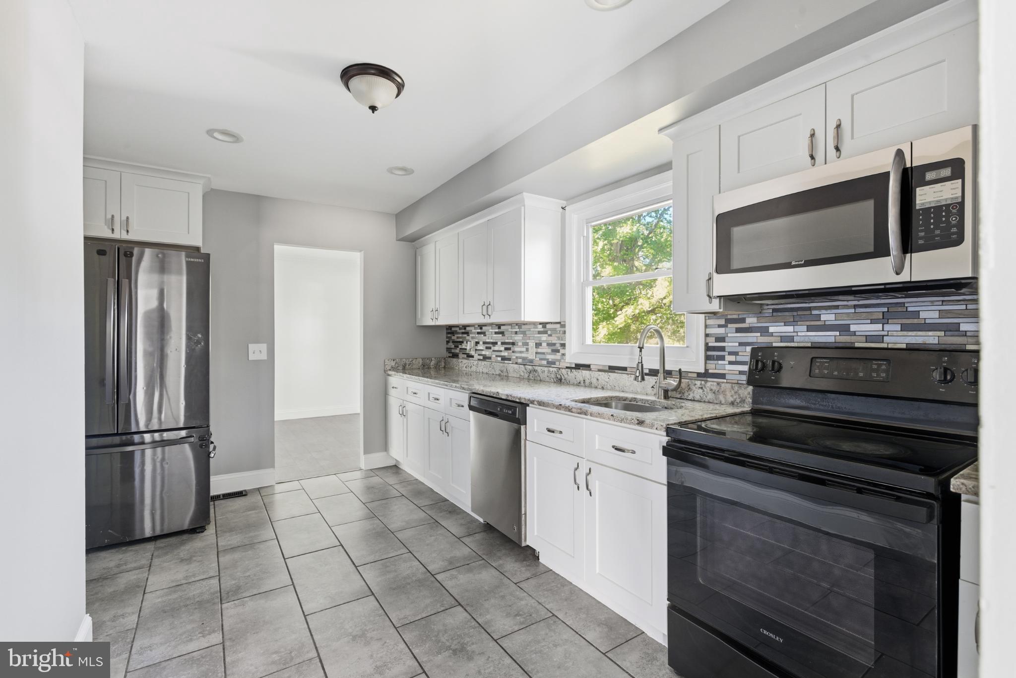 1826 Hanson Road Edgewood, MD 21040 - Photo 5 of 22 a kitchen with stainless steel appliances a stove sink and microwave