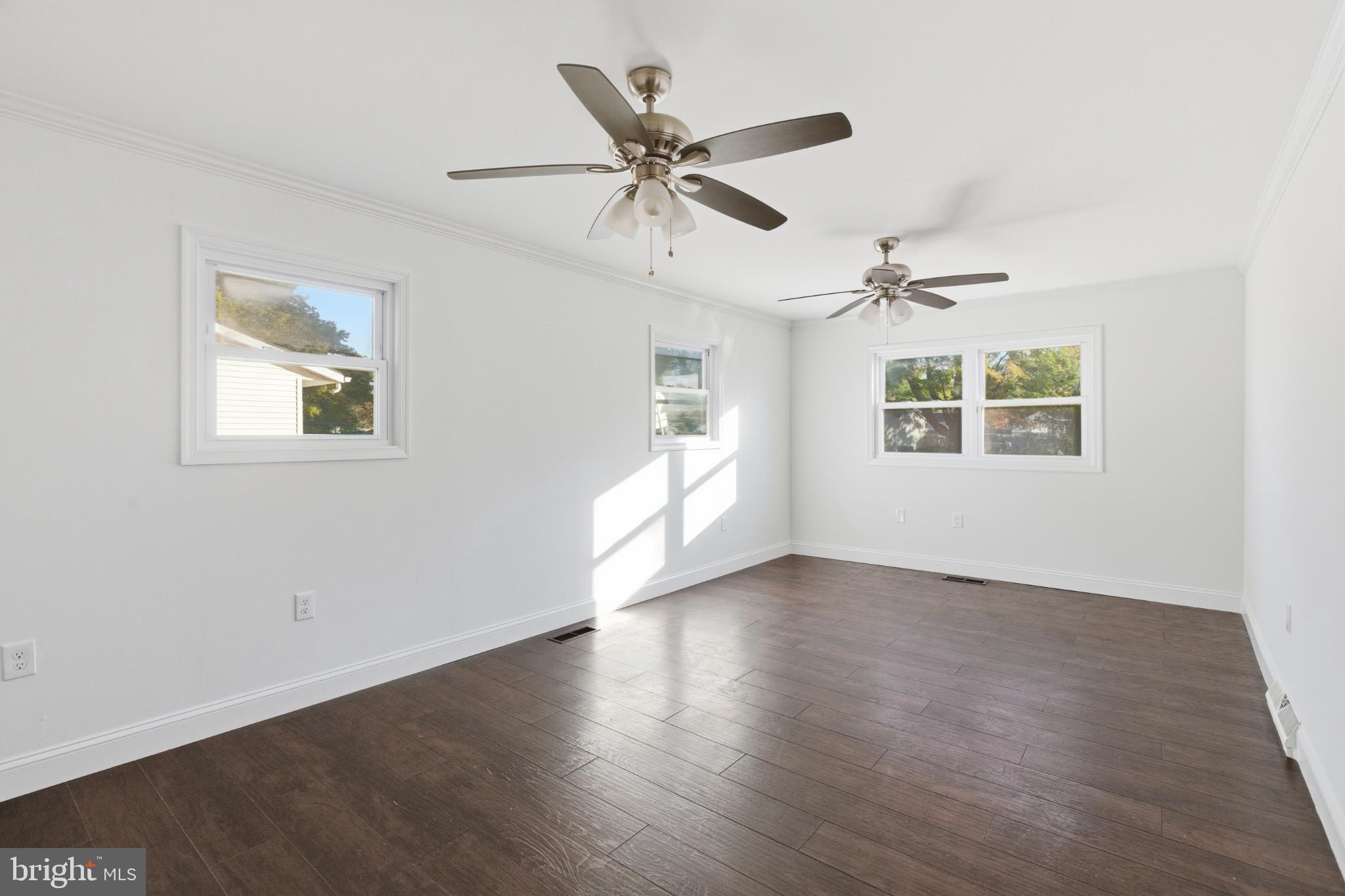 1826 Hanson Road Edgewood, MD 21040 - Photo 7 of 22 a view of an empty room with a window and wooden floor
