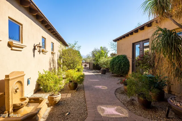 a view of a livingroom with a chandelier fan and a kitchen
