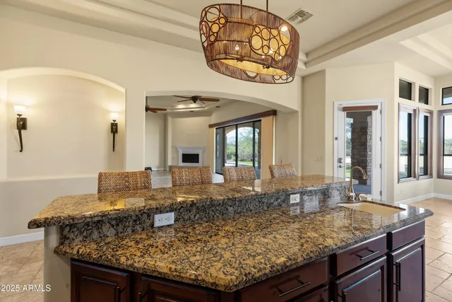 a spacious bathroom with a granite countertop sink mirror and a shower