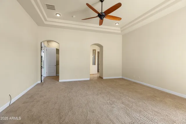 a view of a hallway with wooden floor and a living room